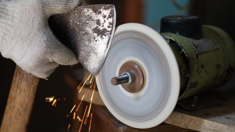 sharpening ax on grinder