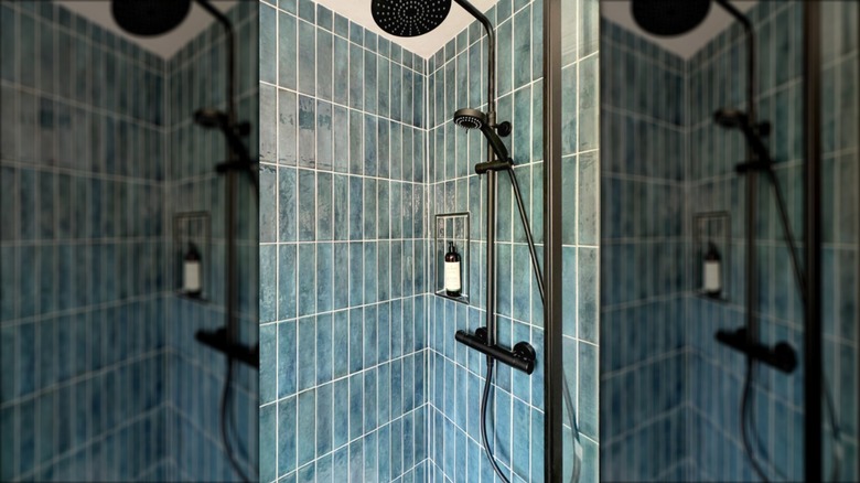 Shower with blue brick tiles and black shower fixture