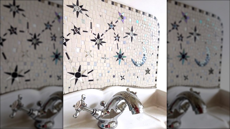 Unique celestial tile backsplash above the bathroom sink