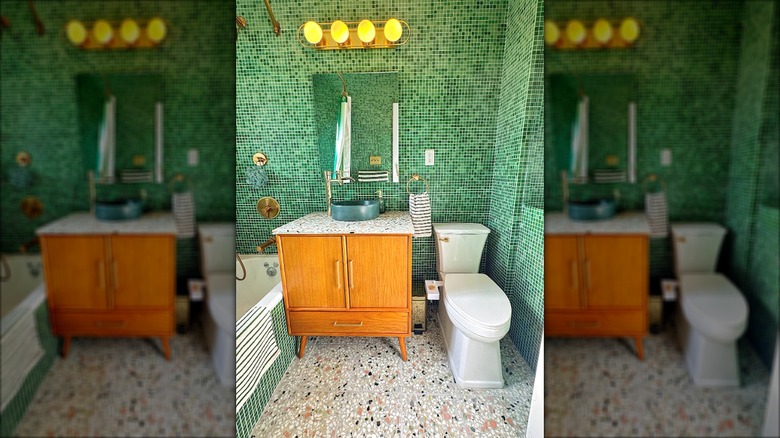 Colorful tiny bathroom with tiny green wall tiles and sandy floor tiles