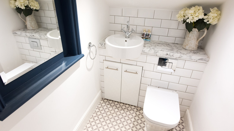 Tiny bathroom with white subway tiles