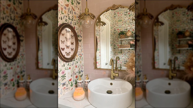 Feminine bathroom with pink tiles and floral wallpaper