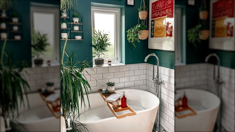 Well decorated tiny bathroom with green walls and white tile around the bathtub