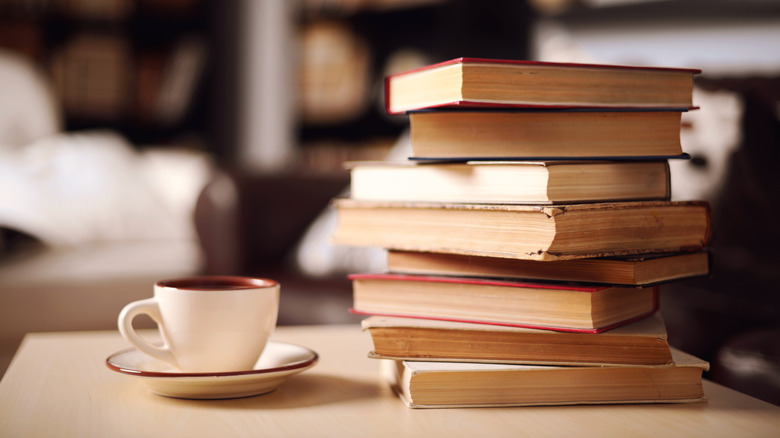 Stack of books by mug