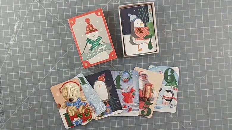 Matchbox advent calendar with dates made from old greeting cards