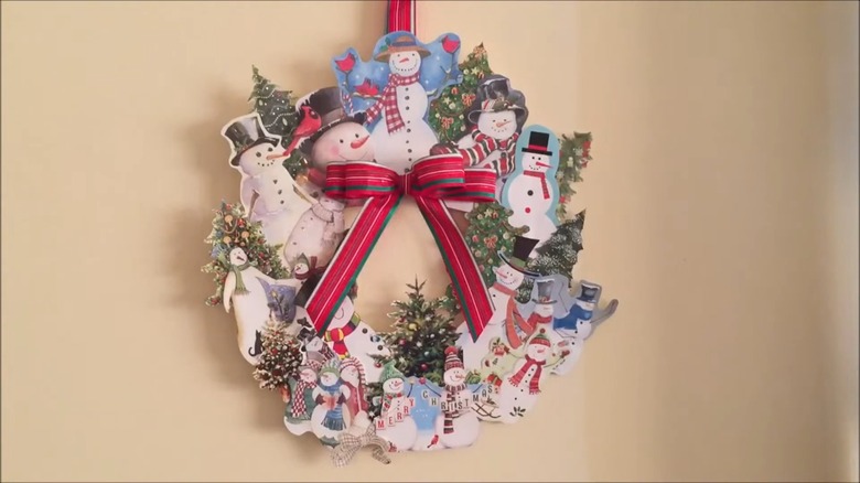 A greeting card wreath hanging on a door