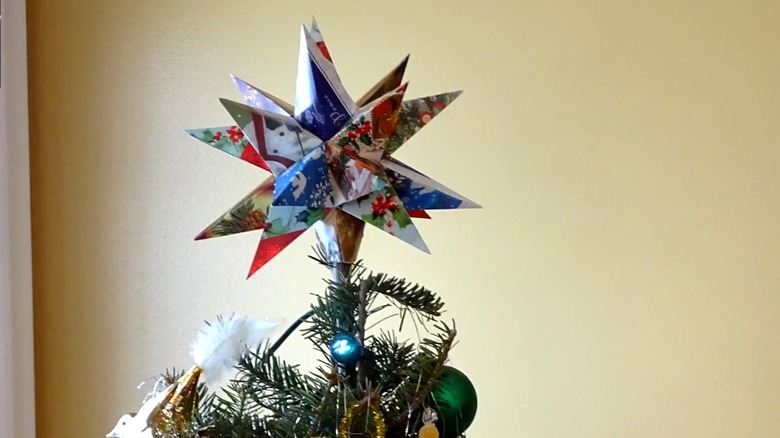 A Christmas tree topper made from old holiday cards