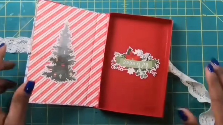 Red and white gift box with lace and holiday stickers