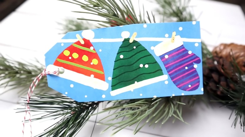 Colorful gift tag with string made from old greeting card