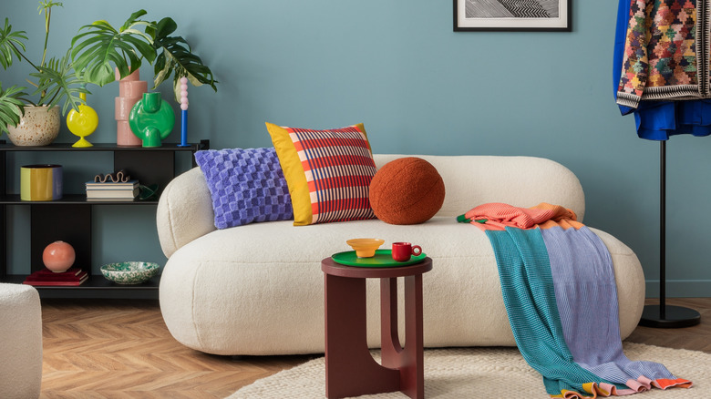 Bright living room with colorful vases, plants, and ornaments