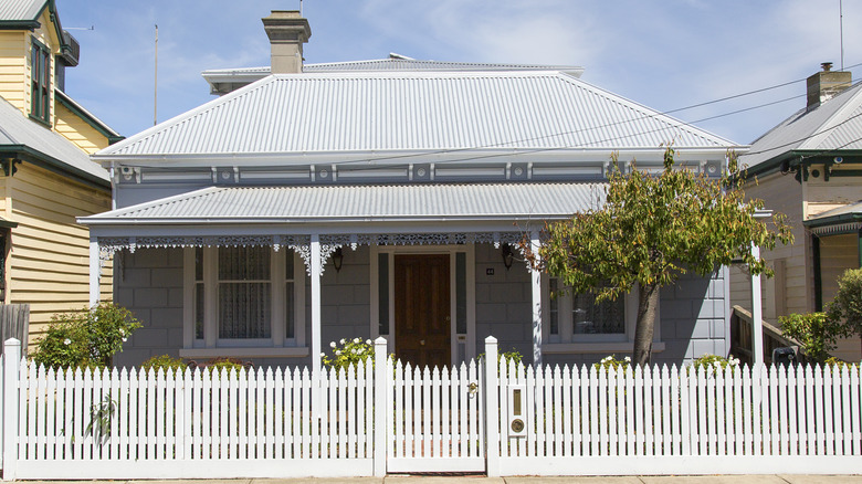 Exterior of bungalow with white fence