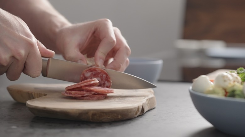 slicing meat on concrete countertop