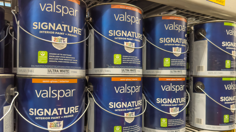 Cans of Valspar Signature semi-gloss lined up in a store