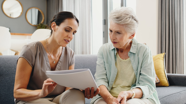 mother and daughter looking at paperwork