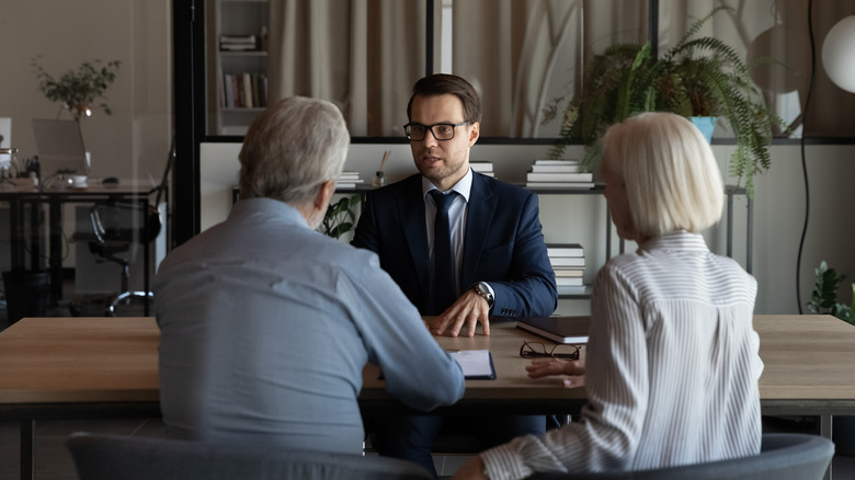 couple speaking with lawyer