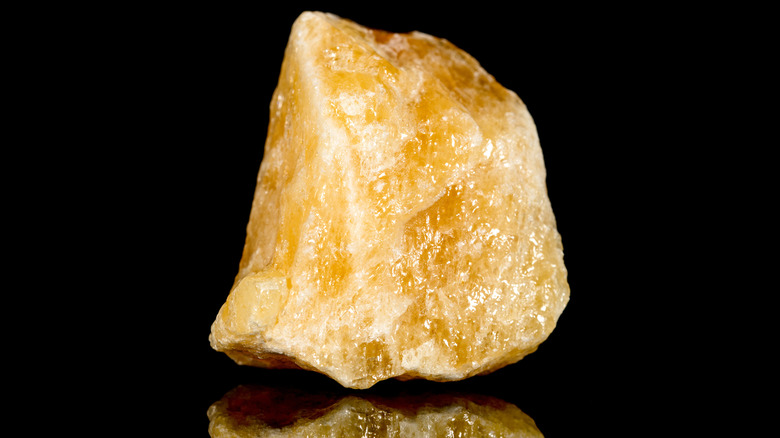 Orange calcite reflecting on table