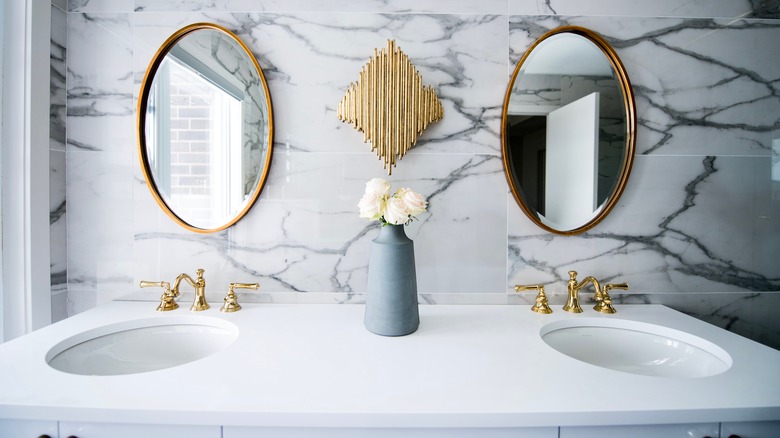 two mirrors over bathroom sink