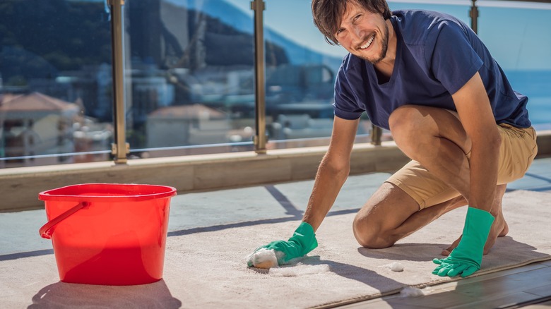 Man washing rug