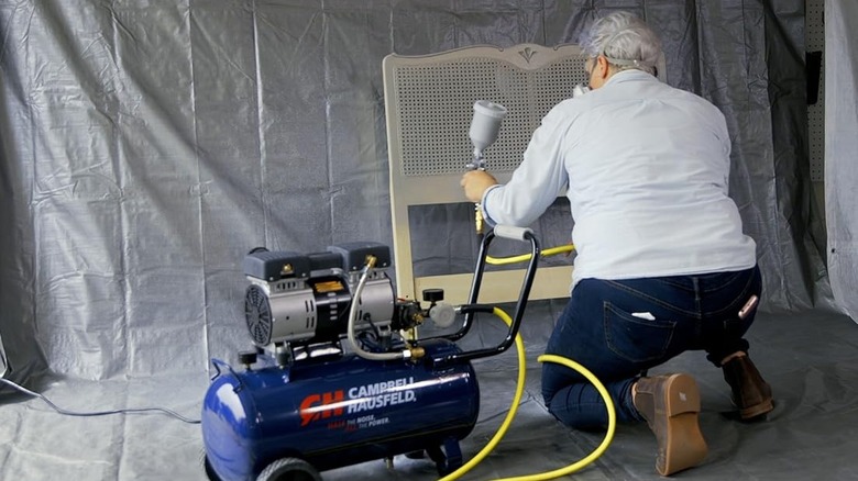 Spraypainting a headboard with a Campbell Hausfeld air compressor