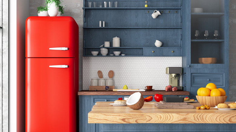 Red refrigerator in blue kitchen