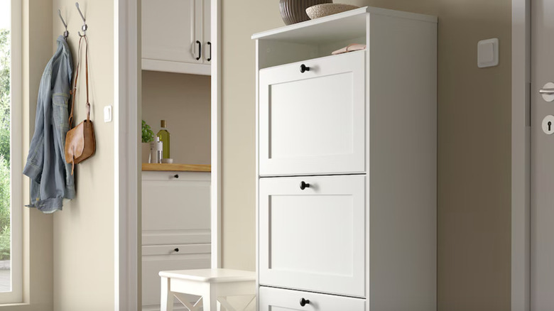 white shoe cabinet with bronze pulls