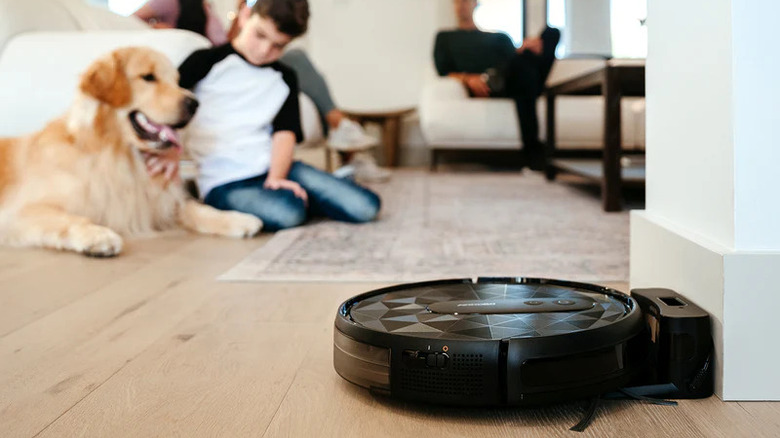 docked robot vacuum with family