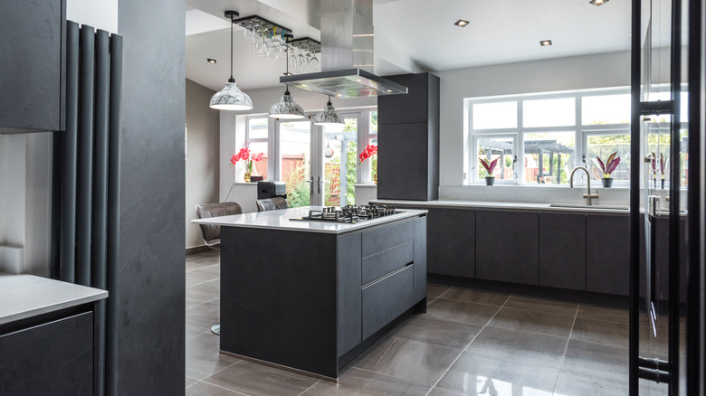 Modern gray kitchen with glossy tile flooring