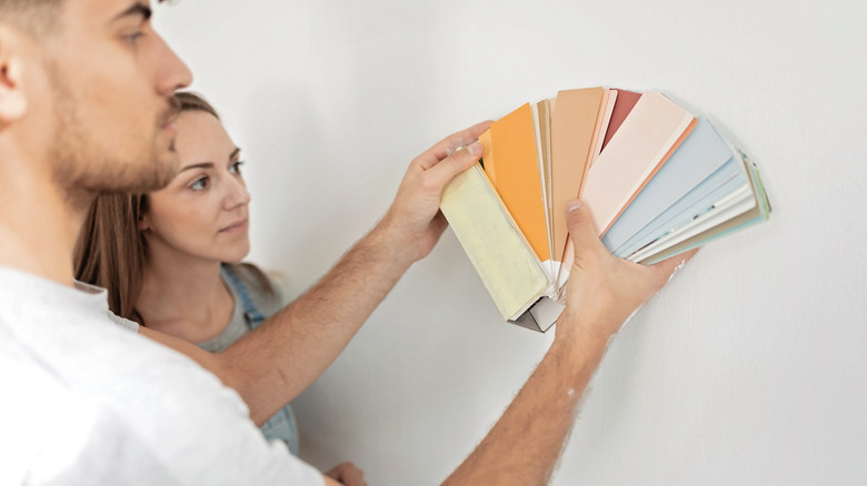 couple considering paint colors wall