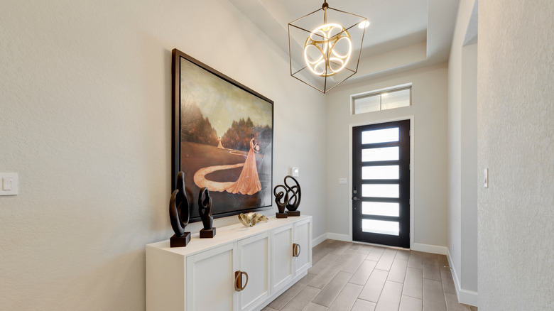 An entryway with a large piece of artwork