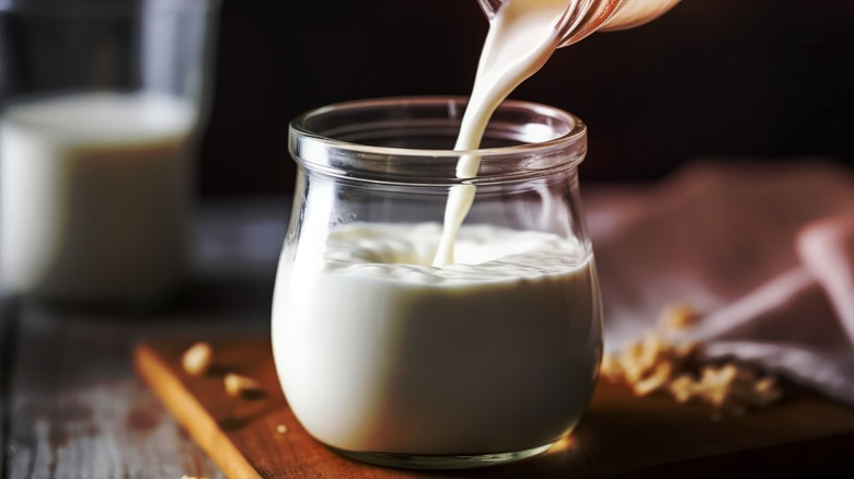 Pouring buttermilk into a jar