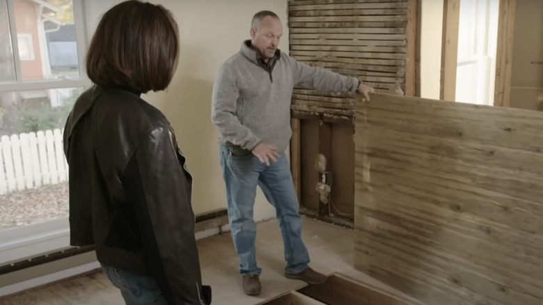 Hilary Farr and contractor looking at crawl space