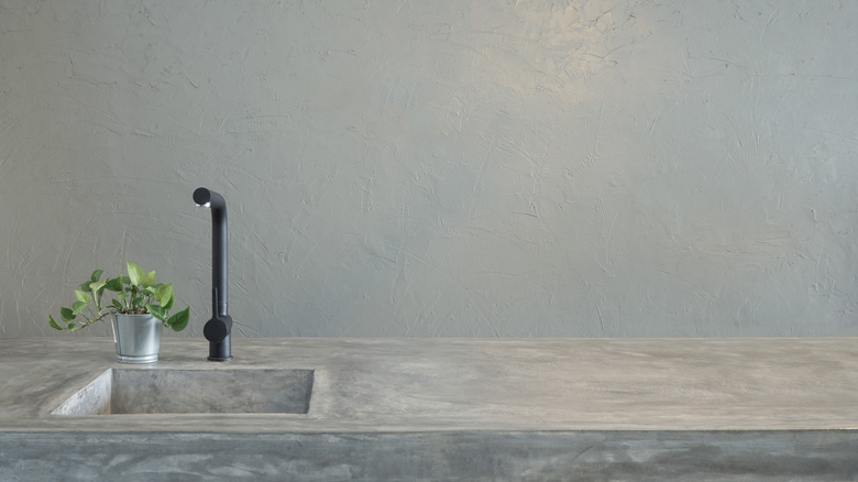 Concrete counter with black faucet