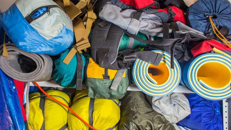 tents and sleeping bags on metal shelves