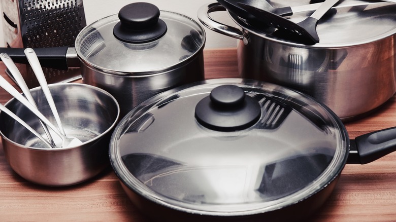 metal pots and pans on wooden surface