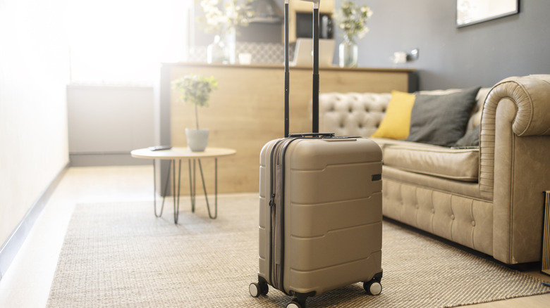 tan suitcase in living room