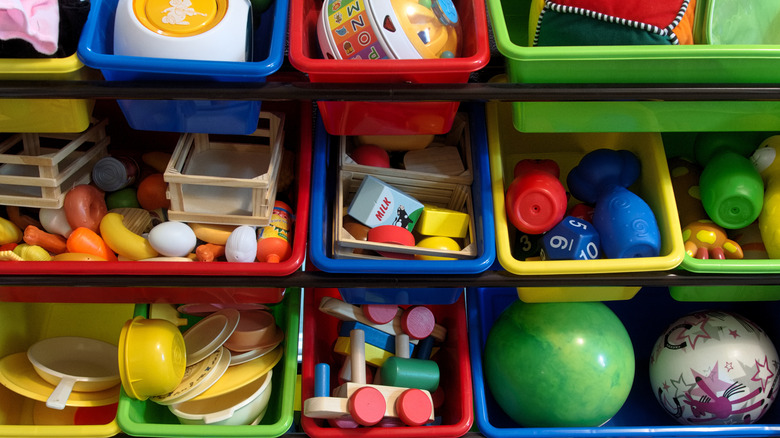 assorted toys in colorful bins