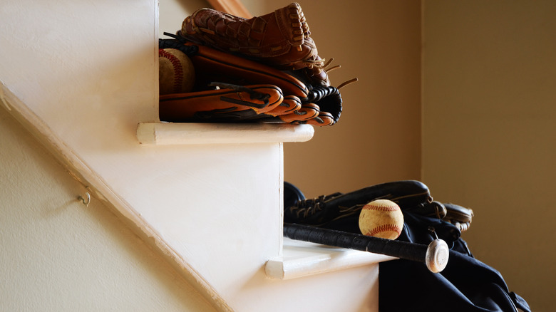 baseball gloves and baseballs on white staircase