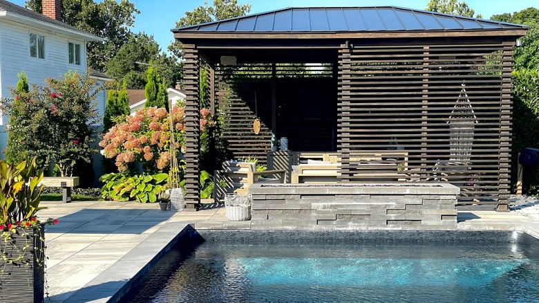 A poolside pergola with privacy walls.