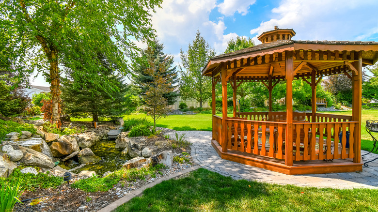 A cedar gazebo in a backyard.