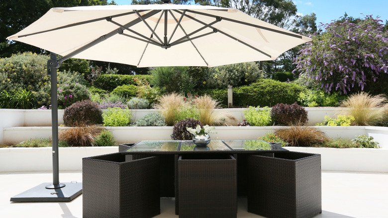 A large cantilever umbrella on a patio.