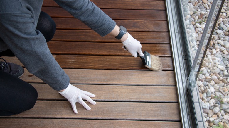 person painting deck