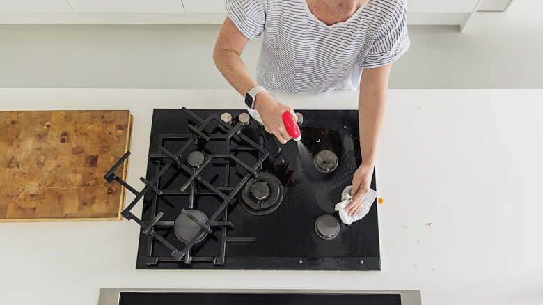 Woman cleaning stove grate