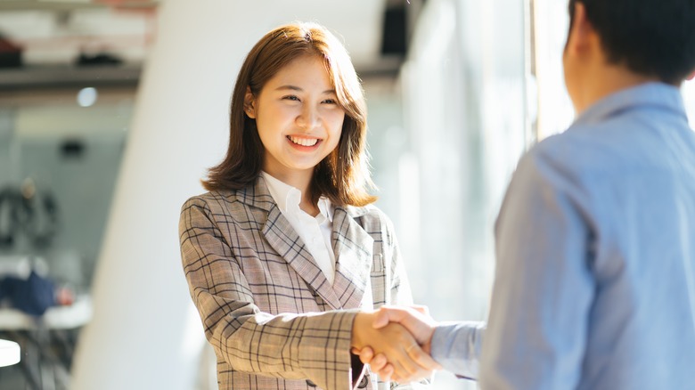 Two business people shake hands