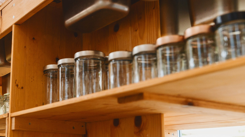 Glass jars on wooden store shelf