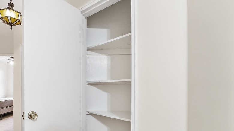 White closet with deep shelves