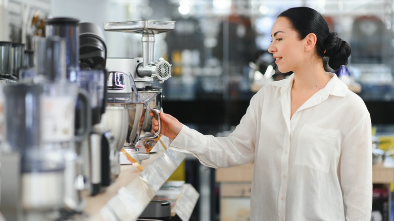 A woman shopping for kitchen appliances.