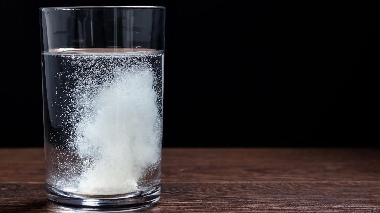 fizzing alka seltzer on a glass of water