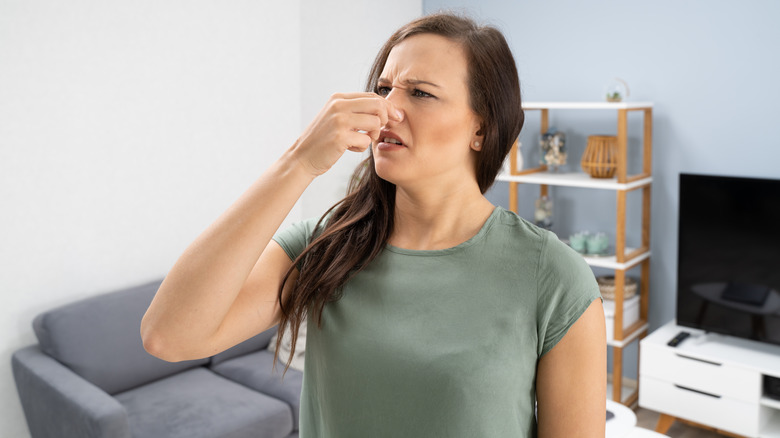 Woman smelling bad odor