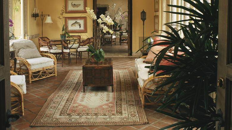 Living room with area rug over tile