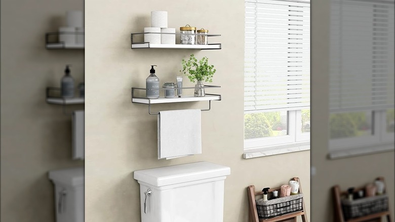 Floating shelves and rack above toilet